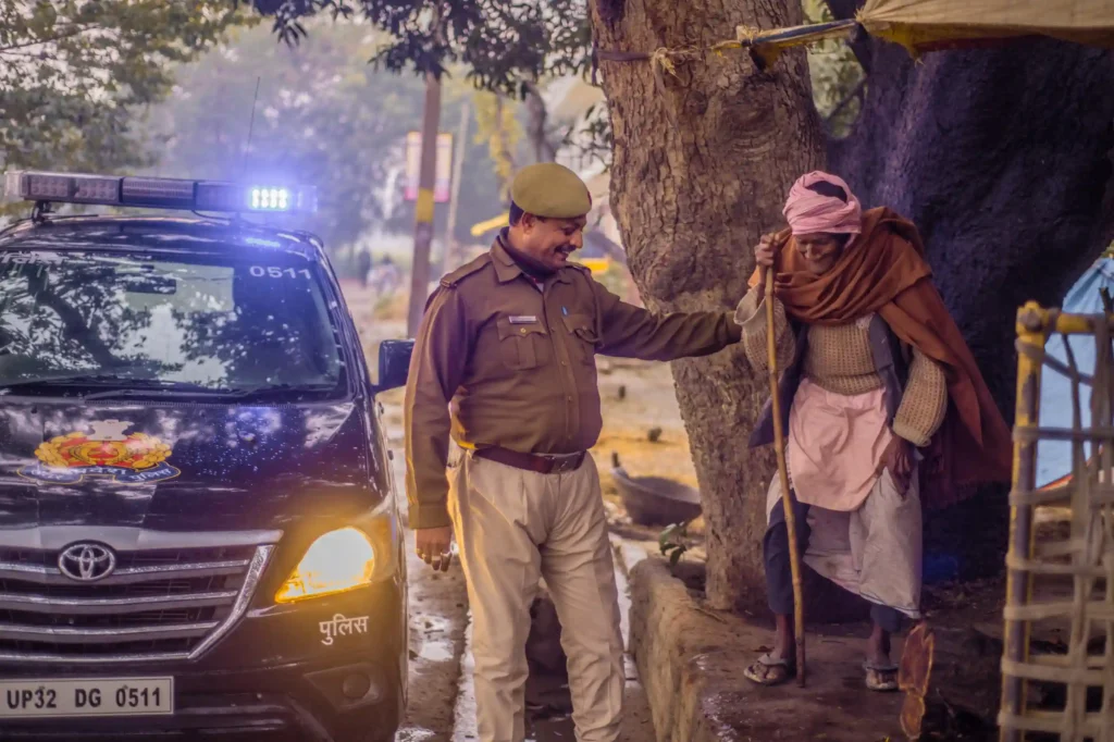 A police person helping an old man in Uttar Pradesh. IPS full form.